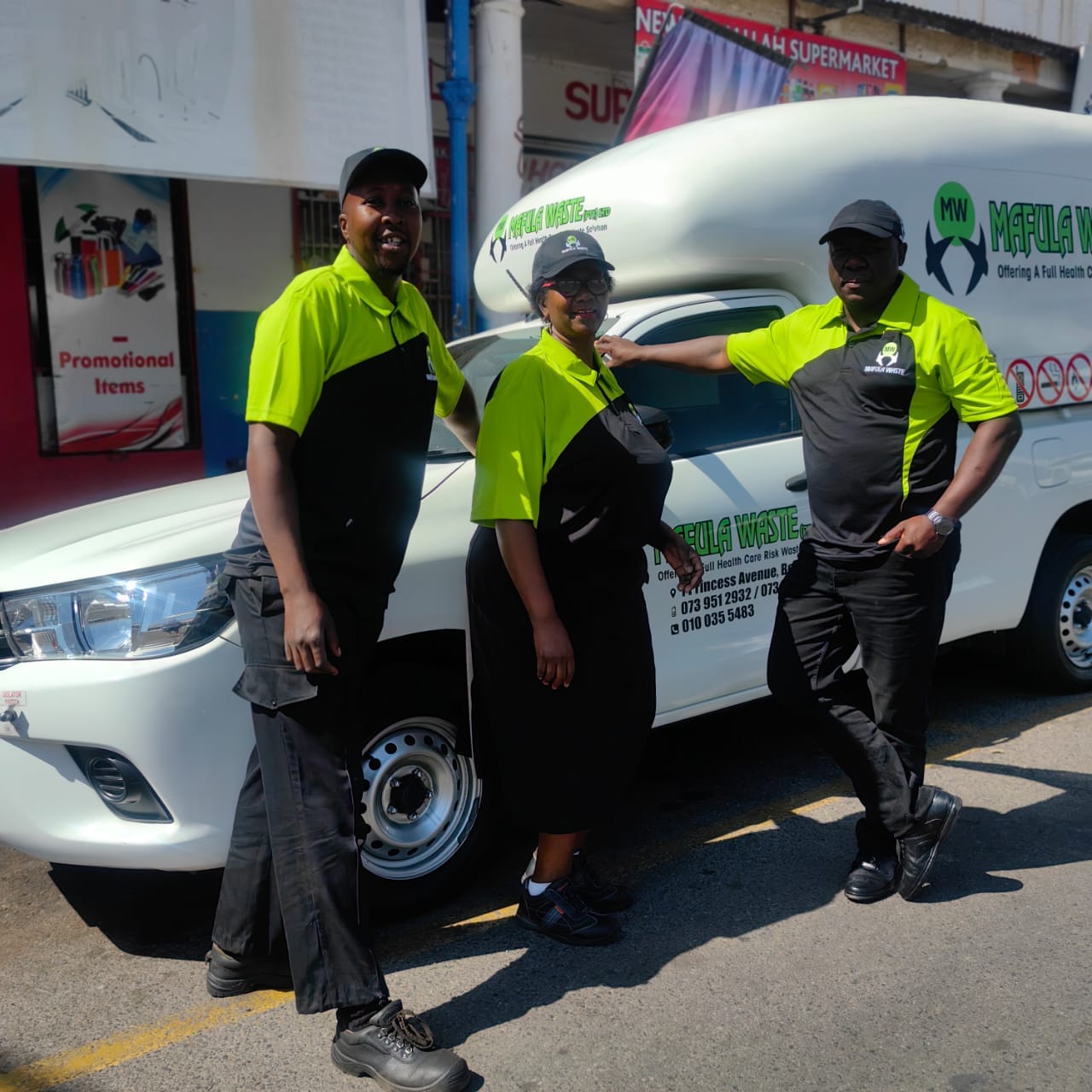 The Mafula Waste team in branded uniform beside a collection vehicle